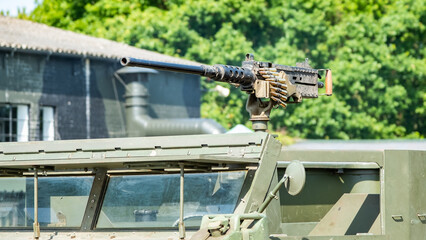 Close up of an automatic machine gun mounted the outside of a military tank used in World War 2 on public display at the annual military day