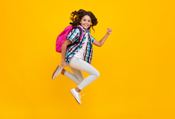 Fototapeta na wymiar Amazed teen school girl. School teen with backpack. Teenager student, isolated background. Learning and knowledge. Go study. Education concept. Run and jump. Excited expression, cheerful and glad.