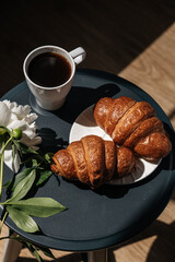 croissants with black coffee in the morning