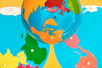 A brightly colored wooden map and globe used in a montessori school for education.