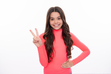 Portrait of funny cheerful teenager child girl showing v-sign isolated over white background. Happy girl face, positive and smiling emotions.