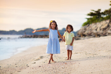 Group of kids playing on tropical beach.