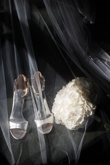 Wedding shoes and bouquet under the veil