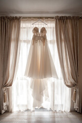 Wedding dress hanging on the window