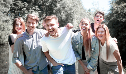 portrait of a group of friends on the background of the Park