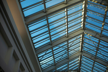 Glass roof in shopping mall. Details of interior in building. Light through glass. Dome in building.
