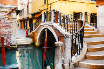 Clorful buildings with a pedestrian bridge. Canal in Venice, Italy