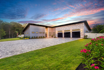 Contemporary home at twilight with driveway and garage