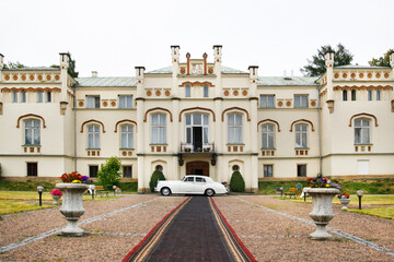 Exterior of a beautiful old house with white retro car