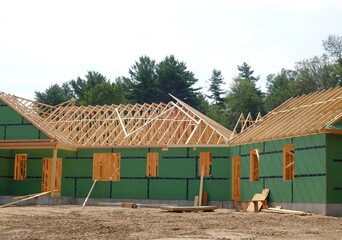 new home and unfinished construction with roof rafters exposed - 508716348