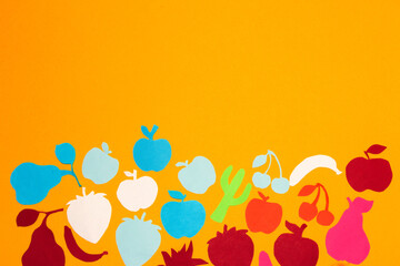 colorful paper fruits at the bottom of the yellow background, creative fruity summer design, minimal concept