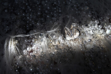Wedding rings on wedding dress background