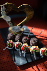 Three wedding rings lie on strawberry desserts