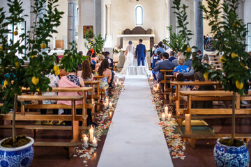 Fototapeta na wymiar Beautiful newlyweds on wedding ceremony in the church