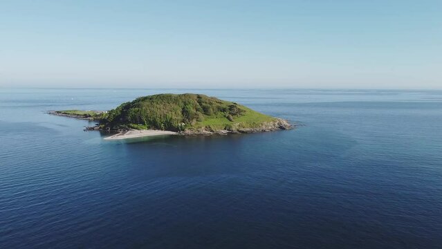 Aerial drone. Crystal clear turquoise water at St Georges Island near Looe, picturesque seaside village. Cornwall, Southwest England, United Kingdom.
