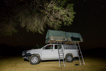 Offroad 4X4 car with tent in African bush during a safari adventure. Camping with a rooftop tent....