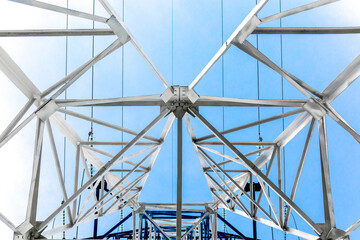 High voltage power lines. metal tower of the power line. Structure of electrical tower. Seen from below