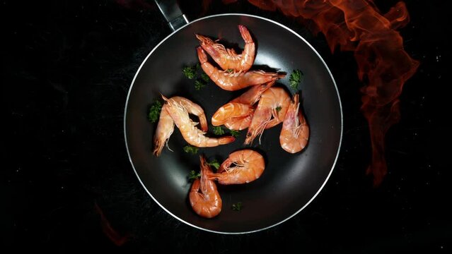 Super slow motion of flying prawns into wok pan with fire blast. Filmed on high speed cinema camera, 1000 fps.