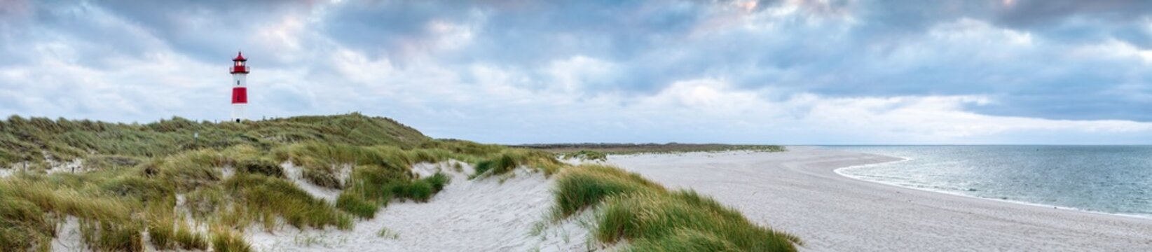 Dune beach with lighthouse on a cloudy day, Sylt, Schleswig-Holstein, Germany