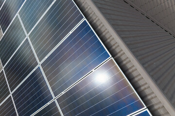Obraz premium Aerial view building roof with rows of blue solar photovoltaic panels for producing clean ecological electric energy. Renewable electricity with zero emission concept