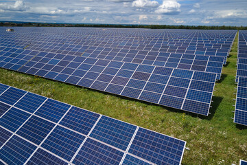 Aerial view of big sustainable electric power plant with many rows of solar photovoltaic panels for...