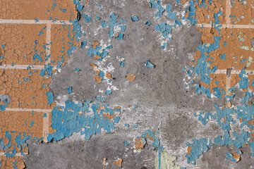 Peeling paint on the wall. Old concrete wall with cracked flaking paint. Weathered rough painted surface with patterns of cracks and peeling. High resolution texture for background and design. Closeup