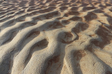 sand that forms waves, due to waves of water currents. natural background