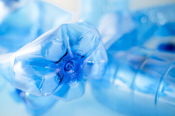 Blue plastic PET bottle in close up on neutral background. Focus on details