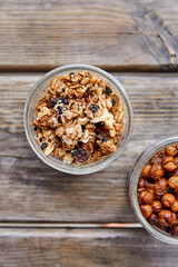Top view of gronola and roasted chickpeas in jars on a wooden picnic table