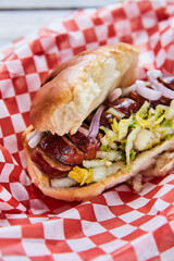Top view of a hot dog in a takeout container