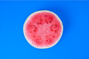 Juicy watermelon sliced into triangles. Top view of  fresh watermelon snaks lying on a blue background.
