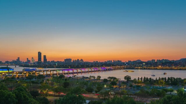 The beautiful moment of the day to the night of the skyline.Rainbow Fountain Show at Bridge banpo in Han river Seoul City South Korea