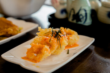 Fried squid rings in white seramic plate 