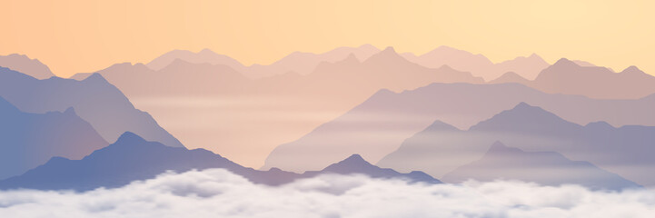 Mountains above the clouds, panoramic view of the ridges in the morning light, picturesque sunrise