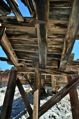 Under an old wooden bridge