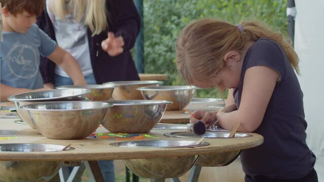 Montessori method of education Children working with enthusiasm at the outdoor children's art workshop.