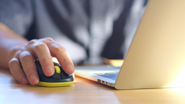 Businessman click mouse on wood table in office or work from home. Concept of technology and working.