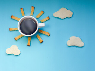 Creative breakfast idea, sunrise morning blue sky with cloud meal, hot black coffee, crispy bread butter sugar and cloudy white bread.