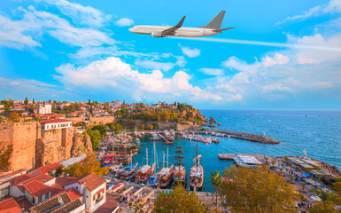 White an air plane fly over the Old Town Kaleici - Antalya, Turkey