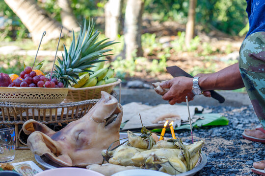 The ritual pays homage to the ancestors of the native villagers using fruit, drink and pig's head. east of Thailand.