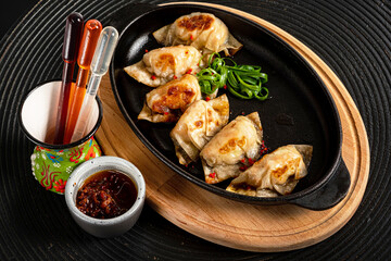 Fried gyoza dumplings with duck served with soy sauce