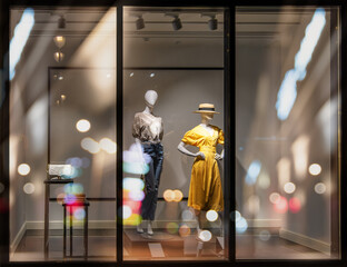 Shop windows and mannequins. Fashion Store exterior. City Night Boutique. Front View from street...