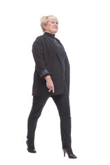 in full growth.confident business woman striding forward.