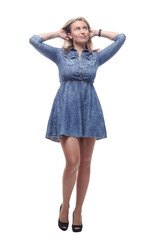 thoughtful young woman in a denim dress looking at a white screen.