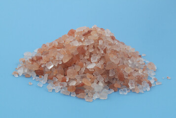 Heap of himalayan rock salt on blue background