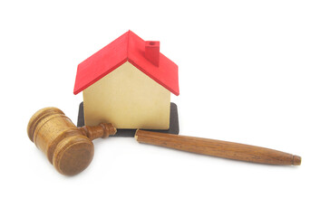 Broken wooden judge gavel and house model isolated on white background. Injustice and deals out of...