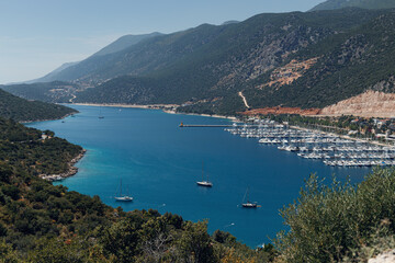 Fototapeta na wymiar Beautiful view of the bay with ships and mountains. Sea bay with luxury yachts on the coast of Turkey. Colorful, summer landscape. Travel concept. Aegean Sea. Journey. Sea Voyage