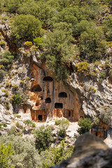 Archaeological remains of the Lycian rock cut tombs. Lycian Tombs. Unique ancient necropolis. Ancient Greek burials. Tourism and attractions. The ancient Greek city of Pinara, Turkey