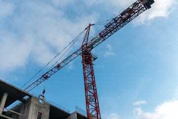 Construction crane against the blue sky. The concept of building a new area. Construction of a new building.