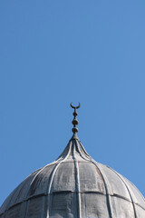 Fototapeta na wymiar mosque dome and crescent symbol covered with lead sheet. Ulucami. The Great Mosque of Adana, Turkey